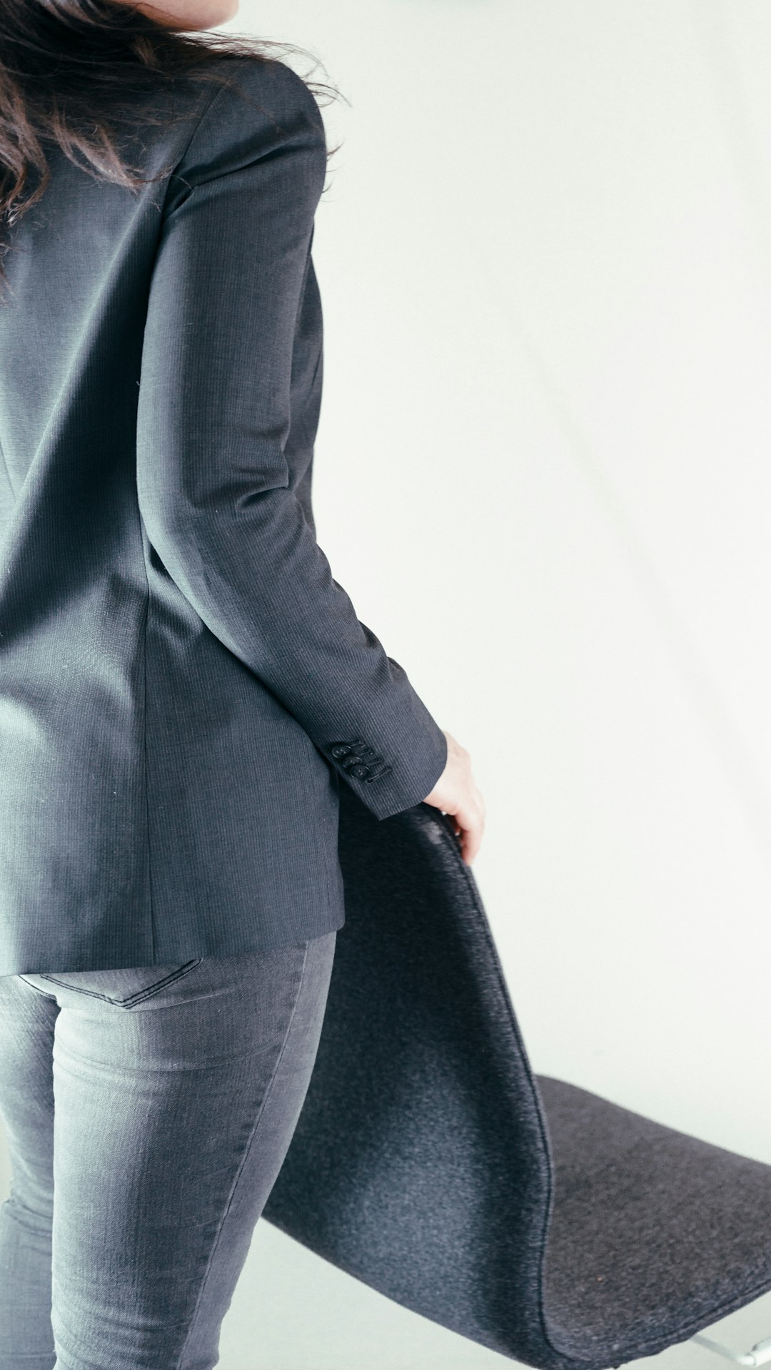 Gray tailored jacket worn with gray jeans